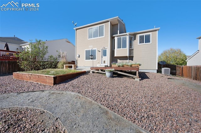 rear view of property with central AC