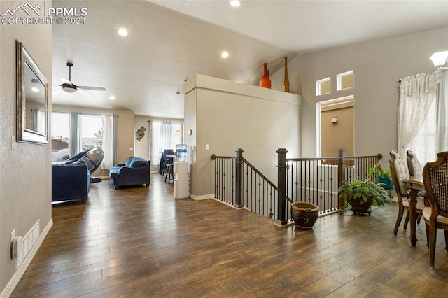 hall featuring lofted ceiling and dark wood-type flooring