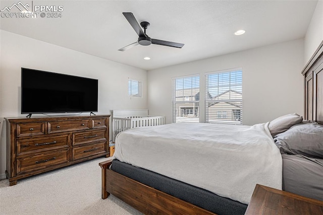 bedroom with light carpet and ceiling fan