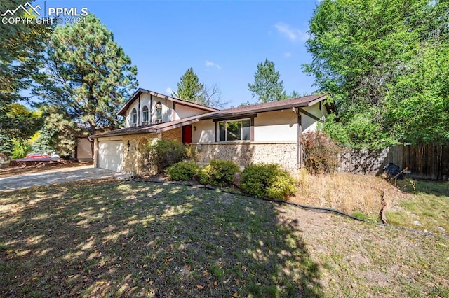 view of front of house with a front yard and a garage