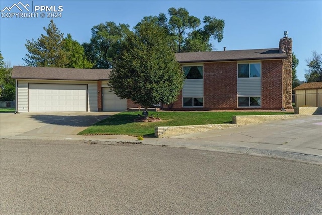 view of front facade with a front yard and a garage