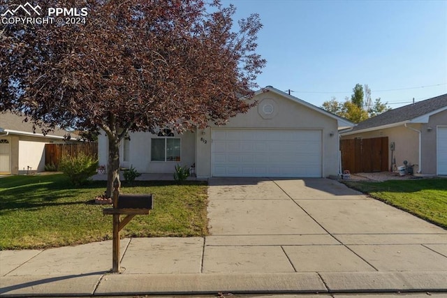 single story home featuring a front yard and a garage