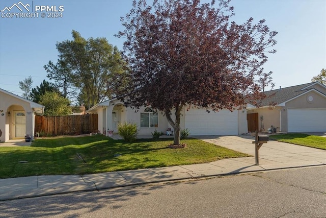 view of front facade featuring a front yard and a garage