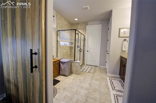 bathroom with a shower with door and vanity