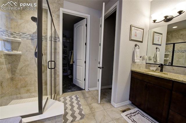 bathroom featuring vanity, tile patterned floors, and an enclosed shower