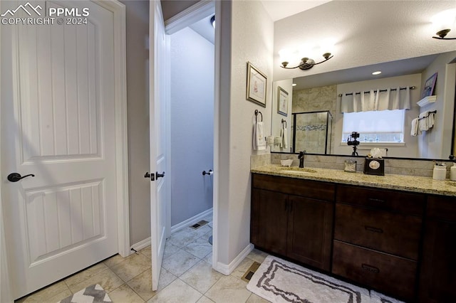 bathroom with vanity, tile patterned floors, a textured ceiling, and an enclosed shower