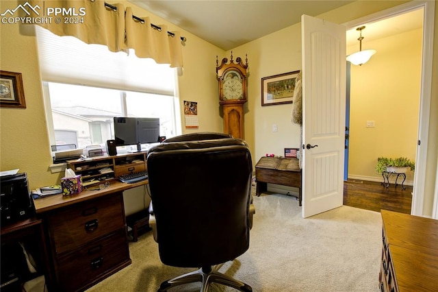 home office with light hardwood / wood-style flooring