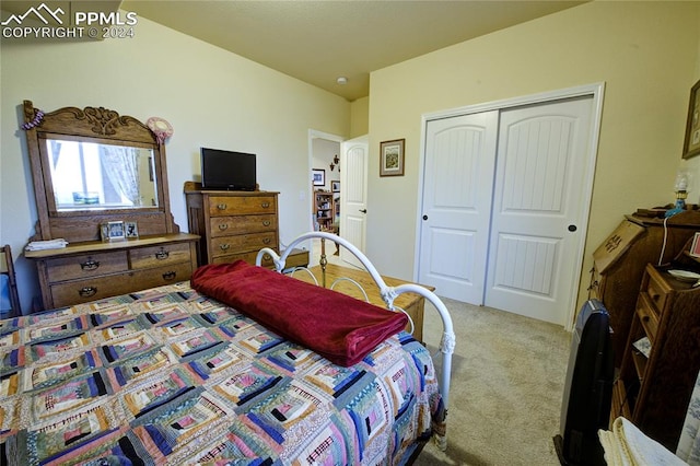 bedroom featuring a closet and light colored carpet