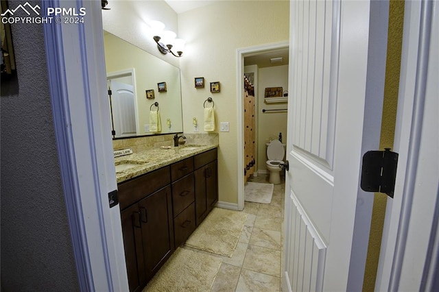 bathroom featuring toilet and vanity