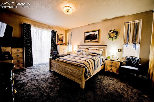 carpeted bedroom with a textured ceiling