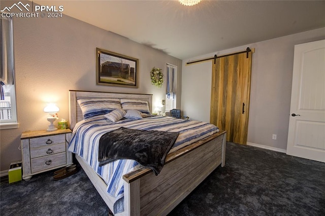 carpeted bedroom with a barn door