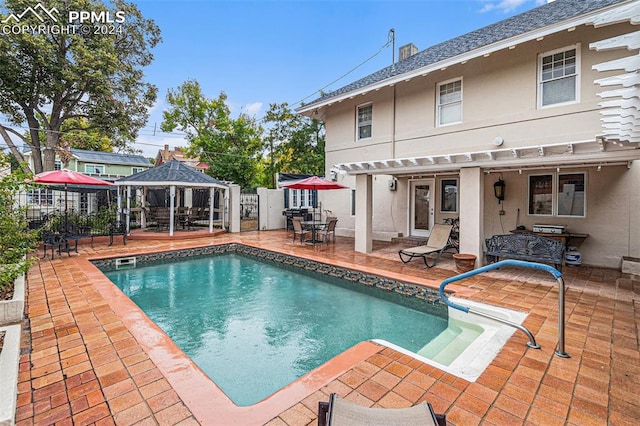 view of swimming pool featuring a gazebo, a patio, and french doors