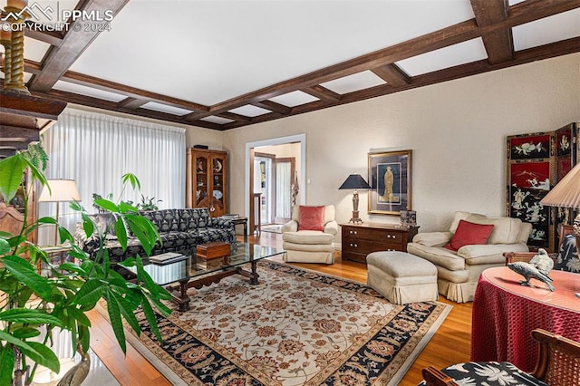 living room with beamed ceiling, coffered ceiling, and hardwood / wood-style flooring