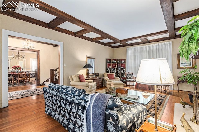 living room featuring beamed ceiling, coffered ceiling, and hardwood / wood-style flooring