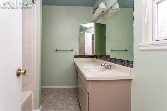 bathroom featuring vanity and independent shower and bath