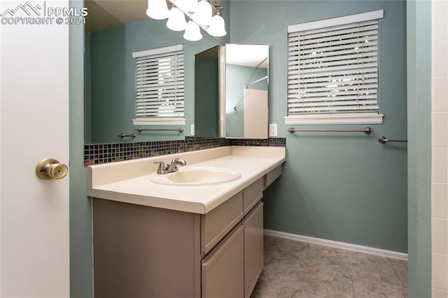 bathroom featuring vanity and backsplash