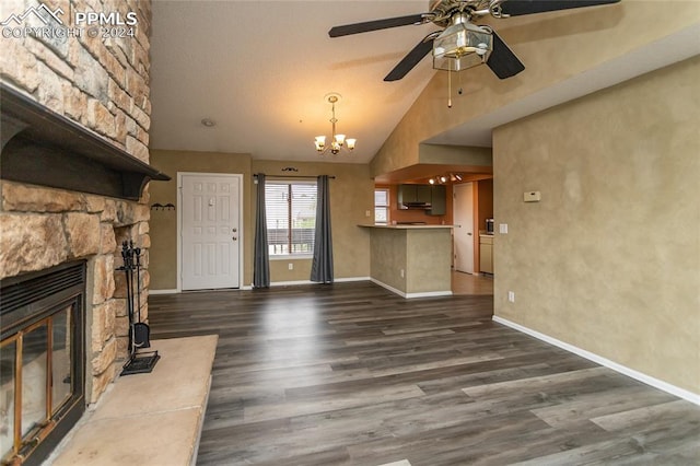 unfurnished living room with a stone fireplace, high vaulted ceiling, ceiling fan with notable chandelier, and dark hardwood / wood-style flooring