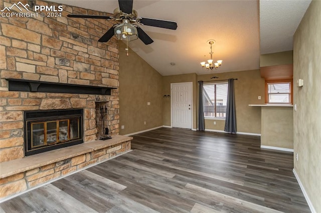 unfurnished living room with high vaulted ceiling, a stone fireplace, a textured ceiling, and dark hardwood / wood-style flooring