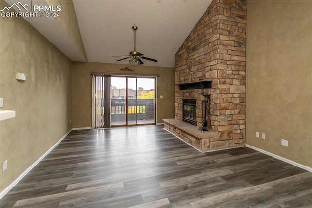 unfurnished living room with a stone fireplace, ceiling fan, high vaulted ceiling, and dark hardwood / wood-style flooring