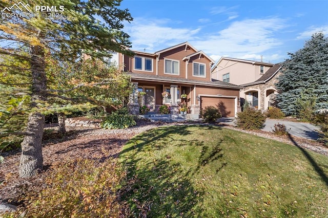 view of front of house with a front lawn and a garage