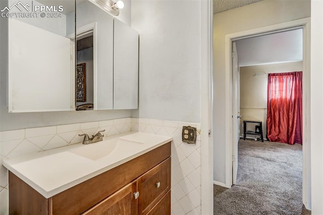 bathroom featuring tile walls and vanity