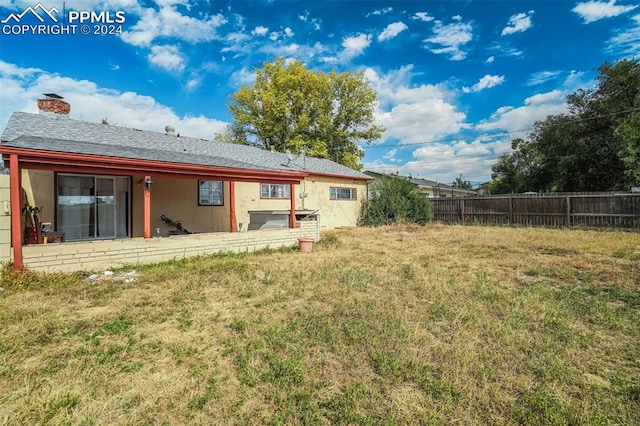 rear view of house with a lawn