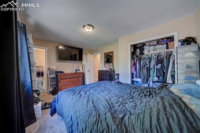 bedroom with light carpet and a closet