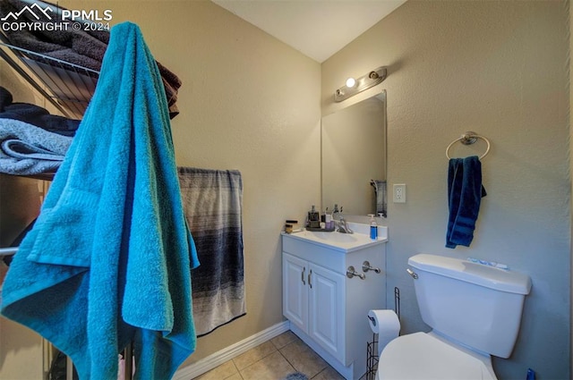 bathroom featuring vanity, toilet, and tile patterned floors