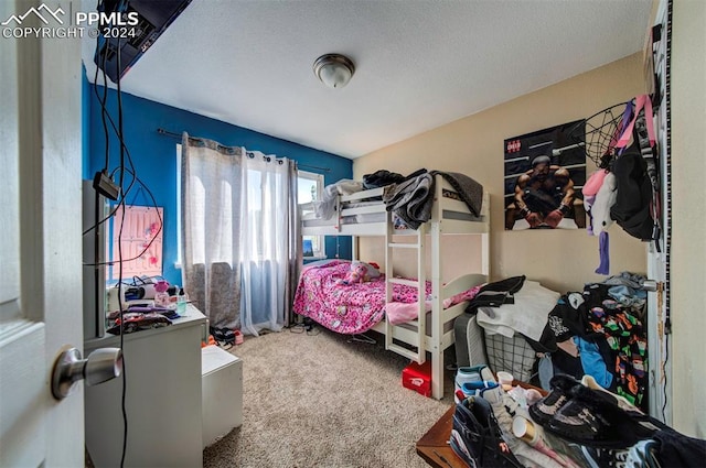 carpeted bedroom featuring a textured ceiling