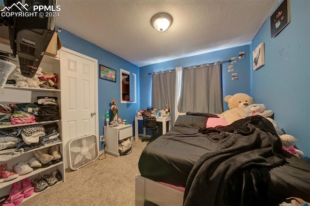 carpeted bedroom featuring a textured ceiling