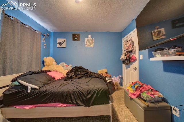 carpeted bedroom featuring a textured ceiling