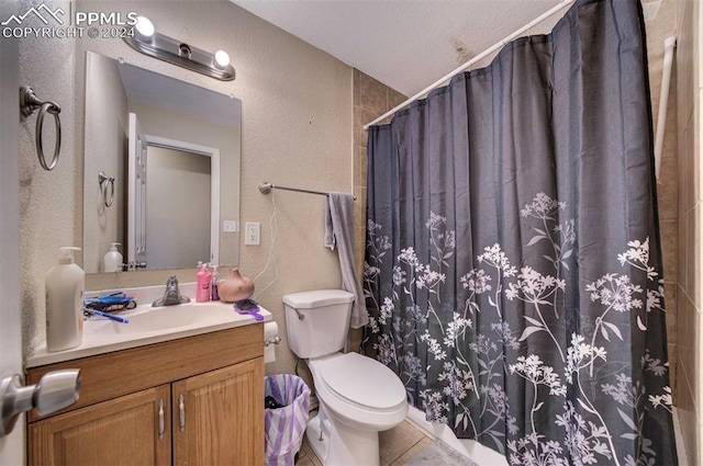 bathroom with toilet, vanity, a shower with shower curtain, and tile patterned flooring