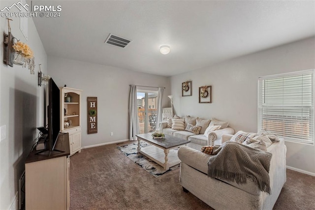 living room with dark carpet