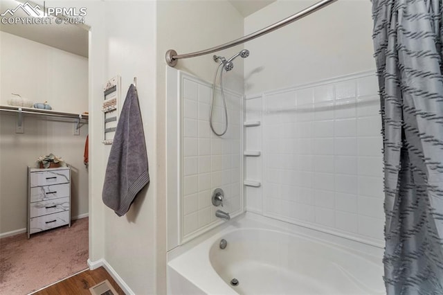 bathroom with shower / bath combination with curtain and hardwood / wood-style flooring