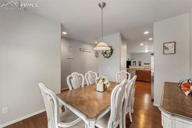 dining space with sink and dark wood-type flooring