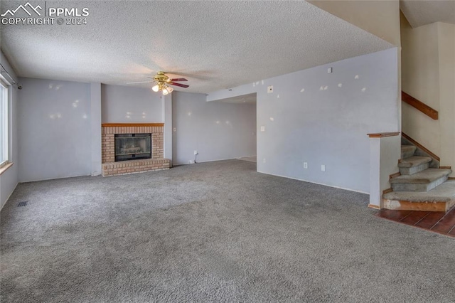 unfurnished living room with ceiling fan, carpet floors, and a textured ceiling