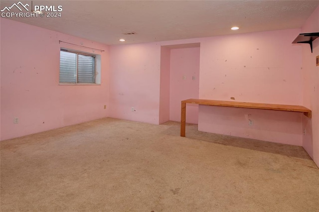 unfurnished room with light colored carpet