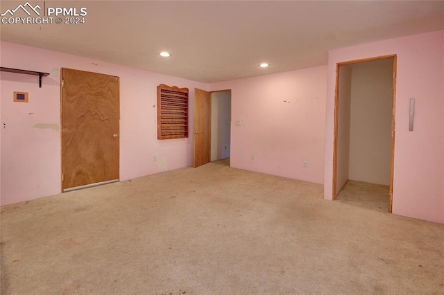 empty room featuring light colored carpet