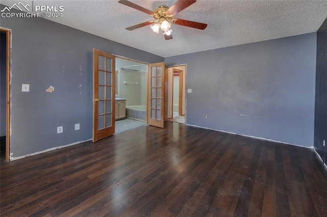 empty room with french doors, a textured ceiling, dark hardwood / wood-style floors, and ceiling fan