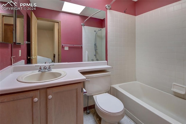 full bathroom featuring vanity, toilet, tiled shower / bath combo, and a skylight