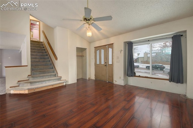 entrance foyer with a textured ceiling, dark hardwood / wood-style floors, vaulted ceiling, and ceiling fan