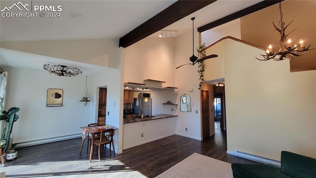 kitchen with sink, beam ceiling, a baseboard heating unit, dark wood-type flooring, and stainless steel fridge