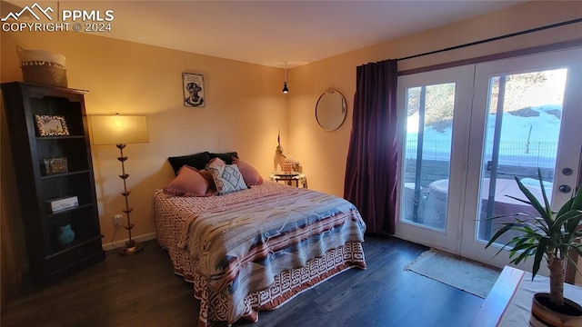 bedroom with access to outside and dark wood-type flooring