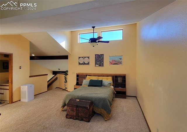 carpeted bedroom with ceiling fan and vaulted ceiling