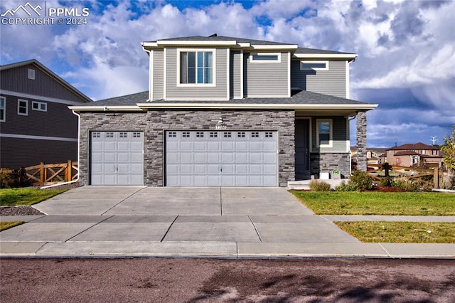 view of front of house featuring a front lawn and a garage