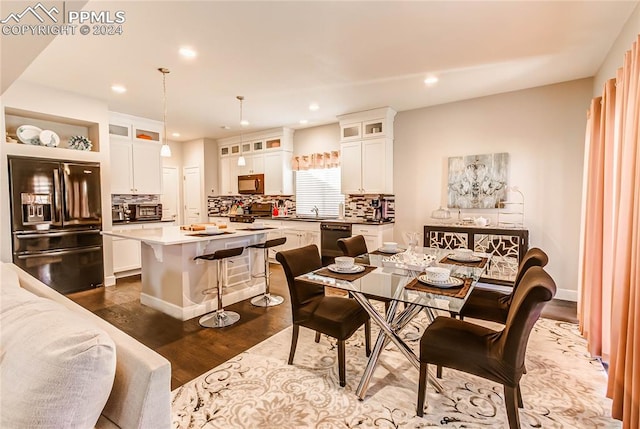 dining area featuring sink and dark hardwood / wood-style flooring