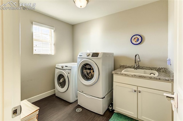 laundry room featuring washer and dryer, sink, and dark hardwood / wood-style flooring