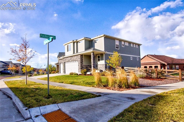 view of front of property with a front lawn and a garage