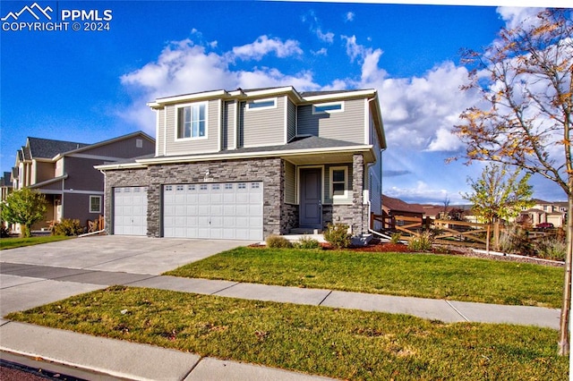 view of front of property featuring a front yard and a garage