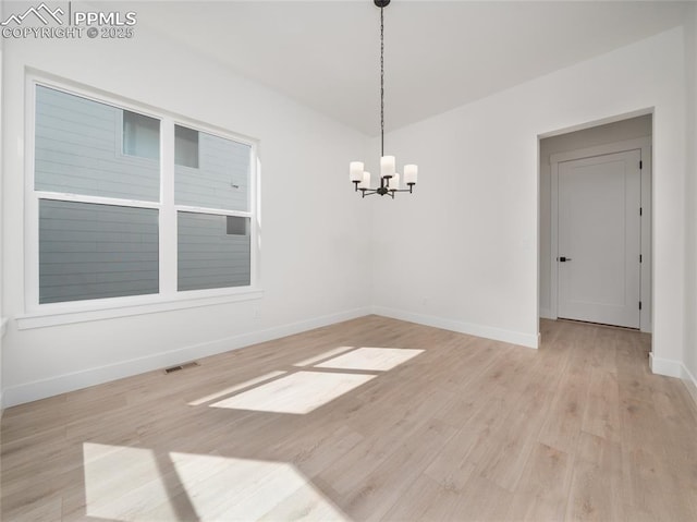 9568 Wolf Valley Dr, Colorado Springs, CO 80924 - unfurnished room featuring a chandelier, light wood-style flooring, and baseboards